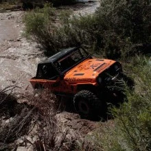 Jason-Kaminsky-Rick-Jenkins-climb-out-of-a-water-crossing..webp