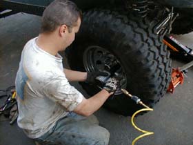 Setting it on the ground and reinstalling the wheels.